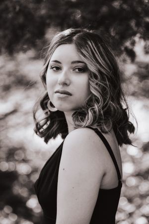 Dramatic black and white portrait series with soft bokeh lighting effects.