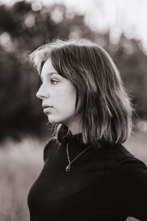 Black and white portrait series showing contemplative profile poses against a blurred background.
