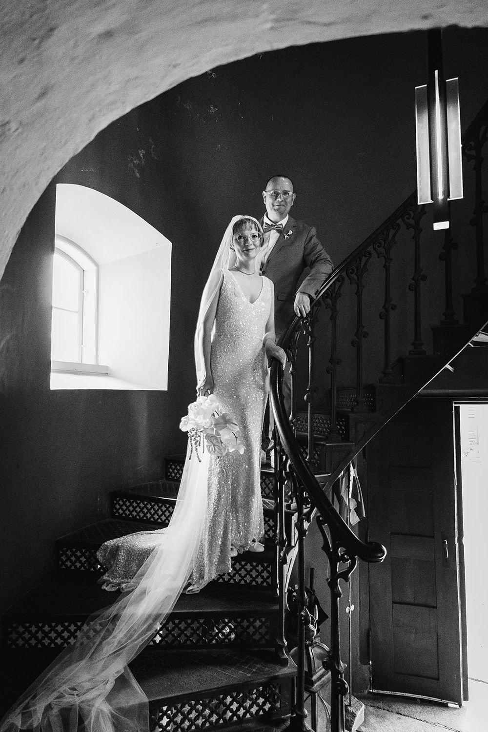 A dramatic black and white wedding photo sequence shows a bride ascending stairs in a flowing dress and veil.