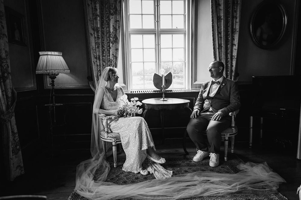A series of black and white wedding photographs displayed in a grid showing intimate indoor moments.