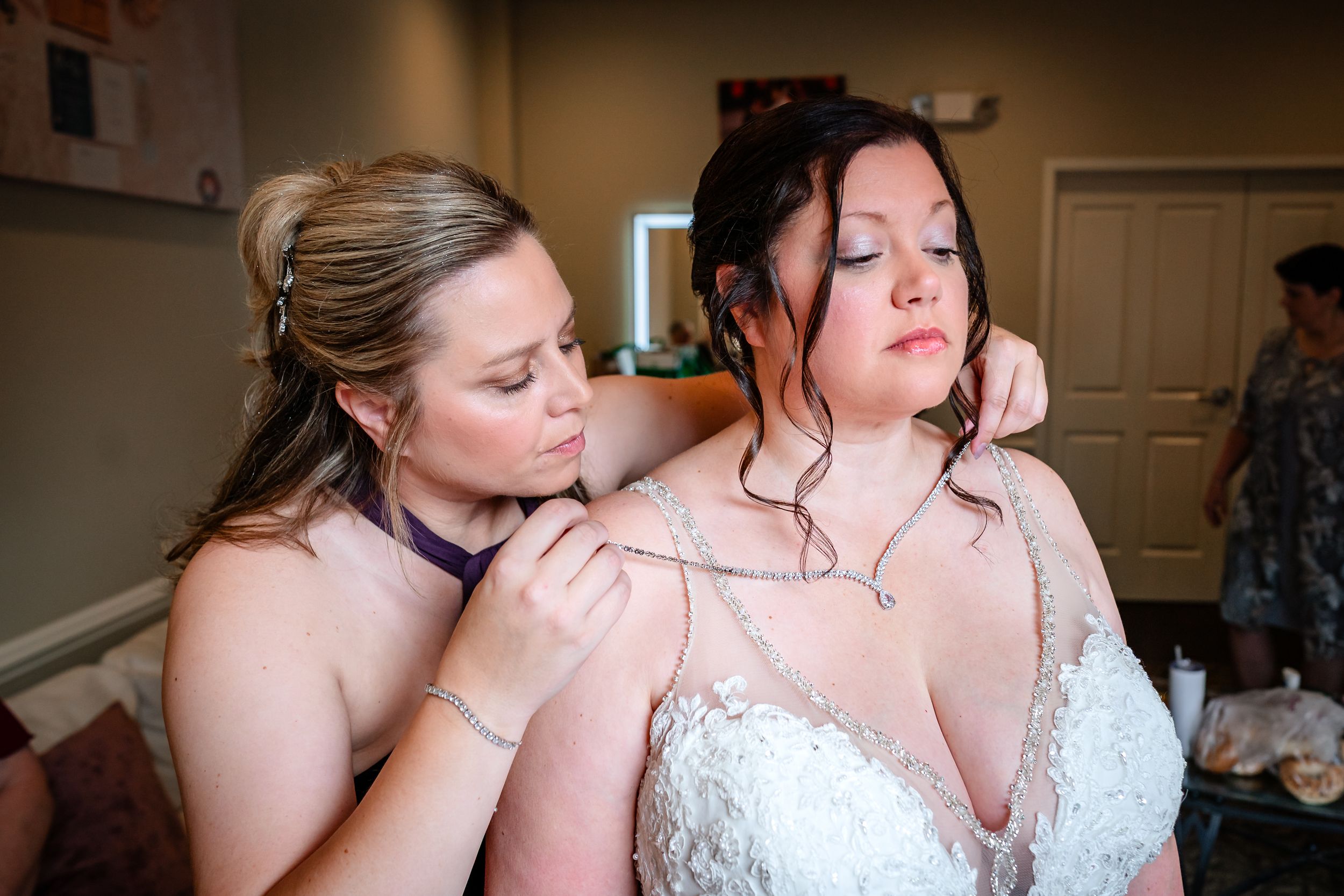 A tender moment of final preparations before the wedding ceremony.