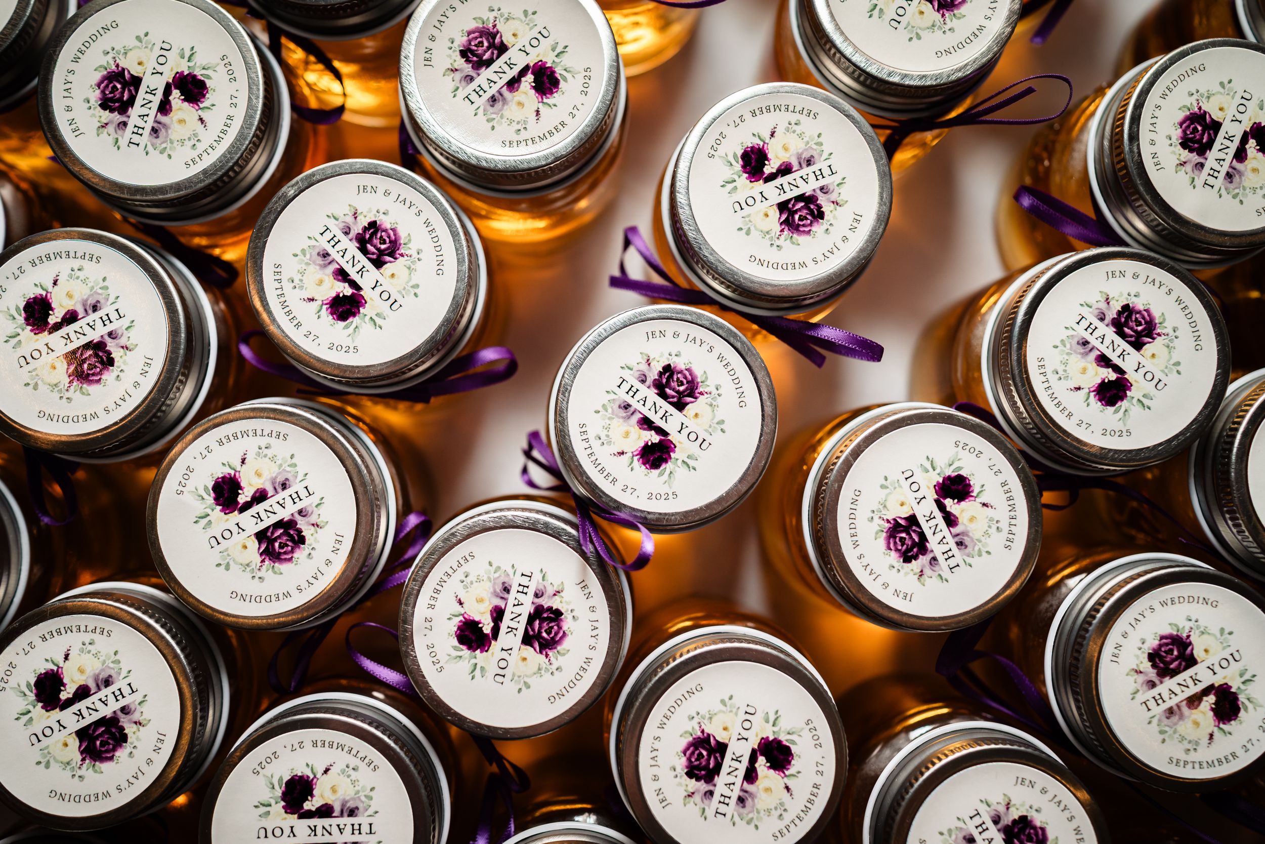 Overhead view of wedding favor jars arranged in neat rows with custom labels.