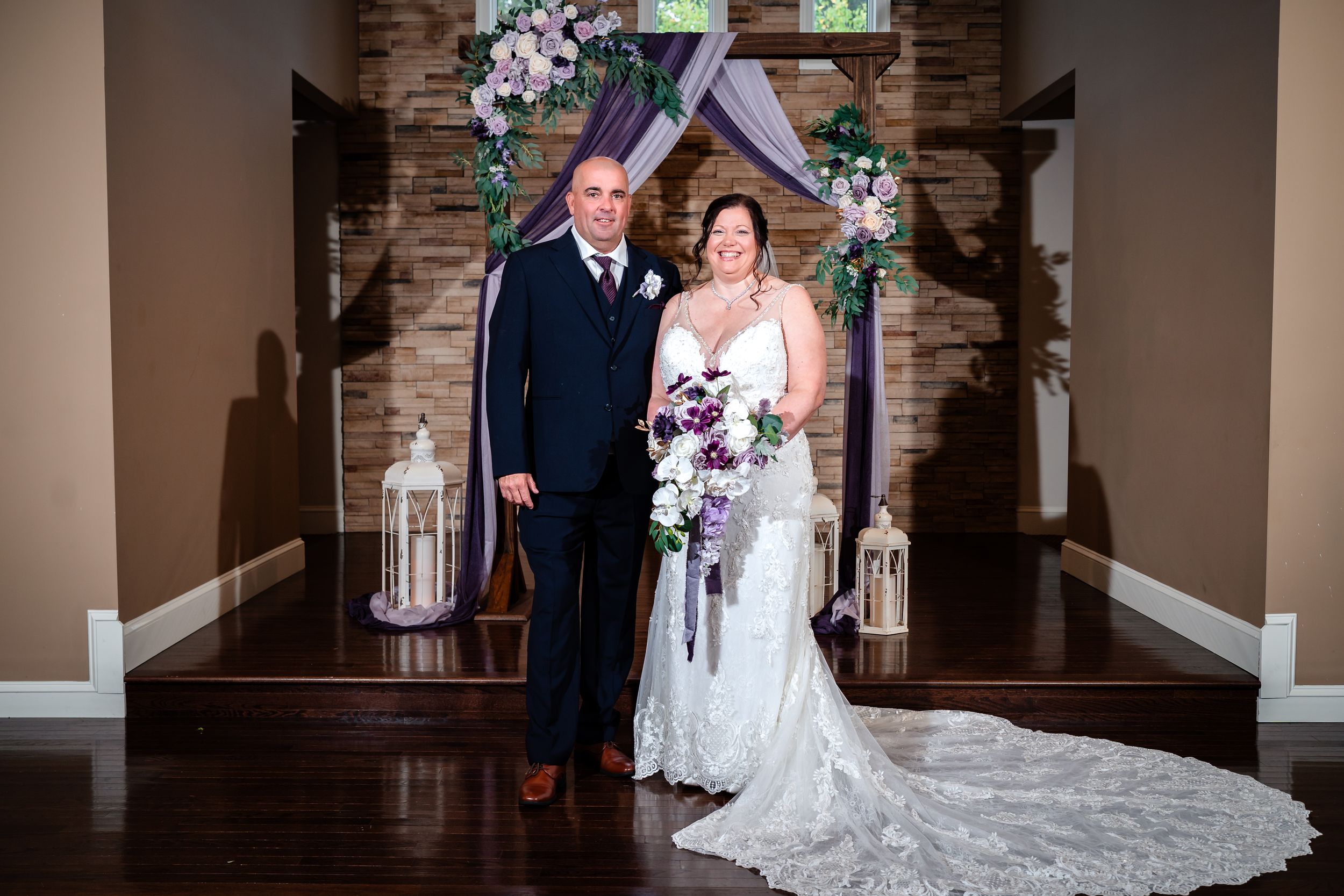 An intimate wedding ceremony moment captured in a chapel with exposed brick and natural lighting.