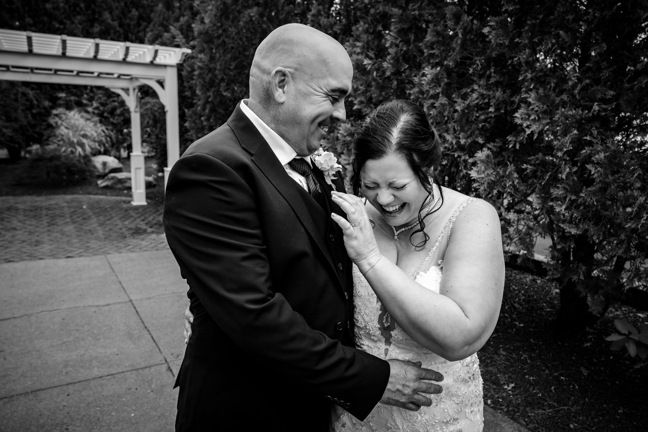 Black and white emotional wedding moments captured in an outdoor setting.