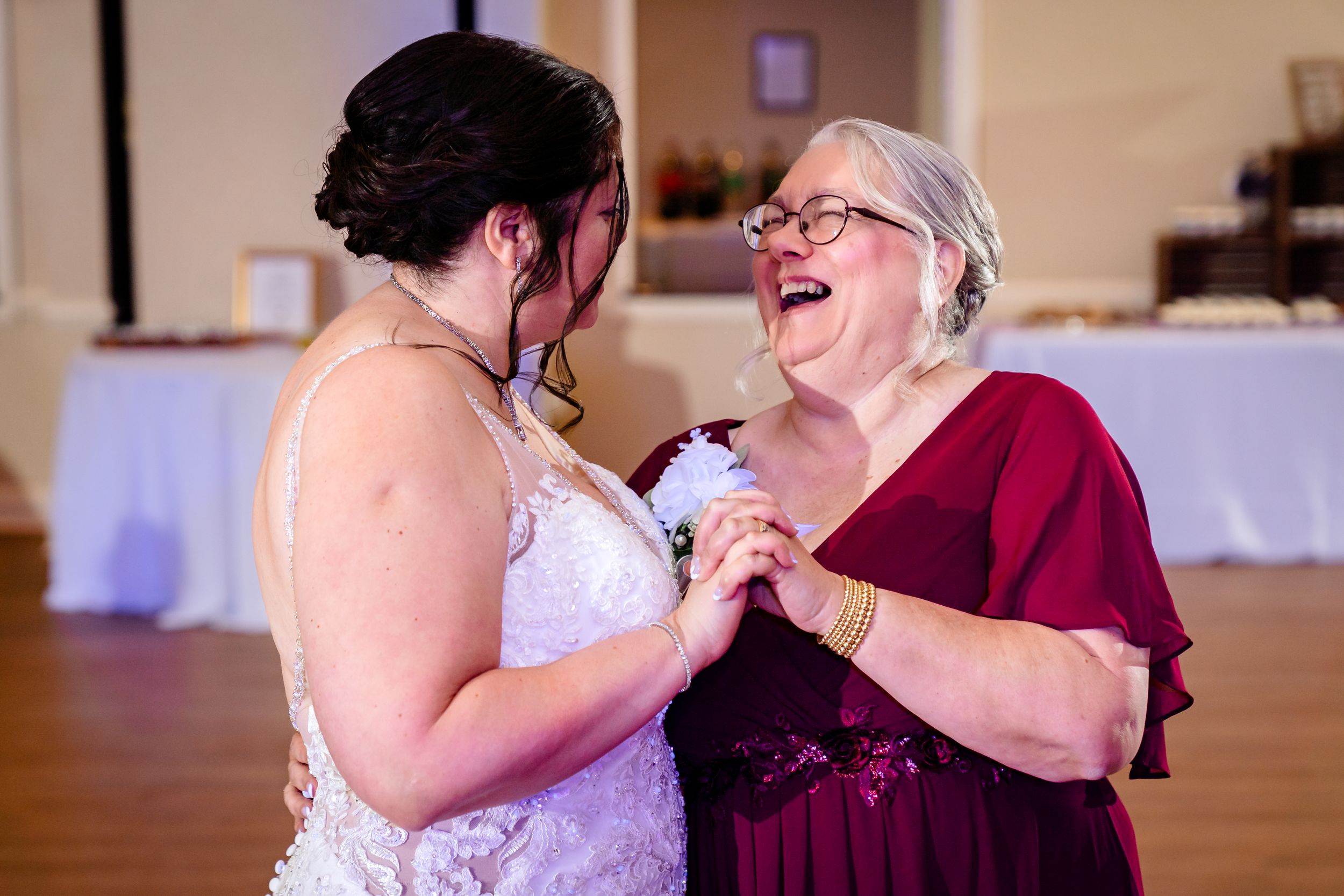 Wedding celebration with guests sharing emotional moments during reception.
