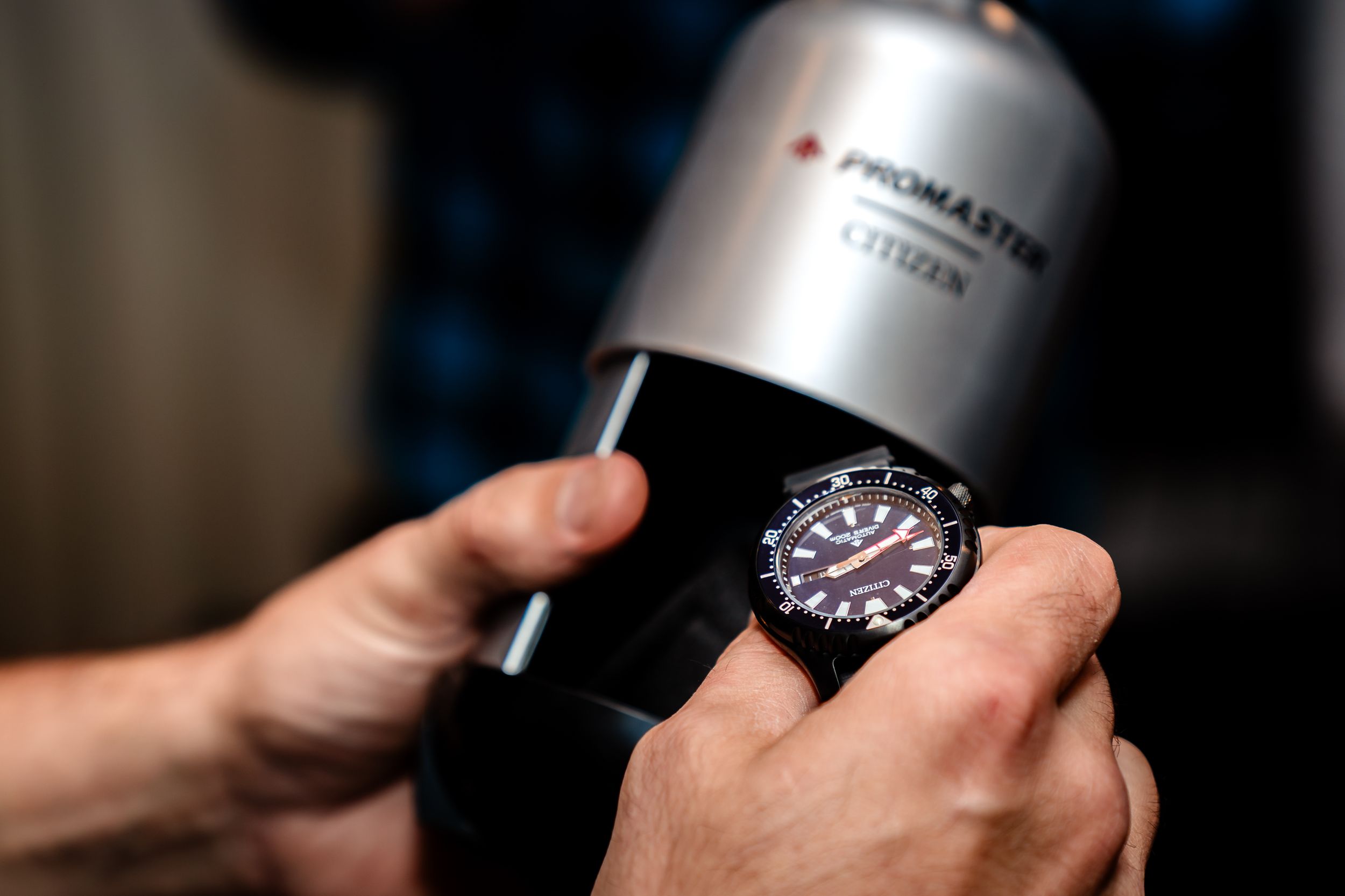 Close-up shots of hands holding metallic flask container.