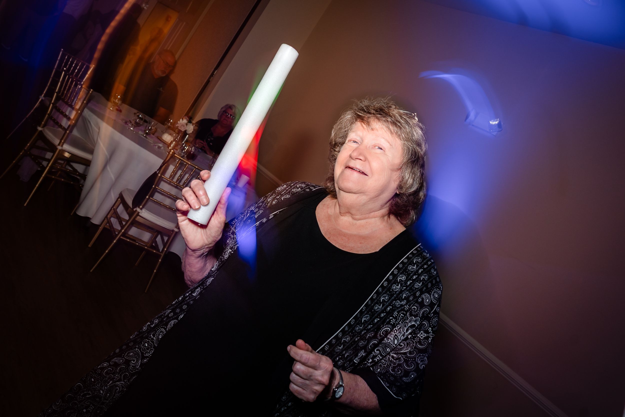 Wedding reception dance floor with blue mood lighting and party atmosphere.