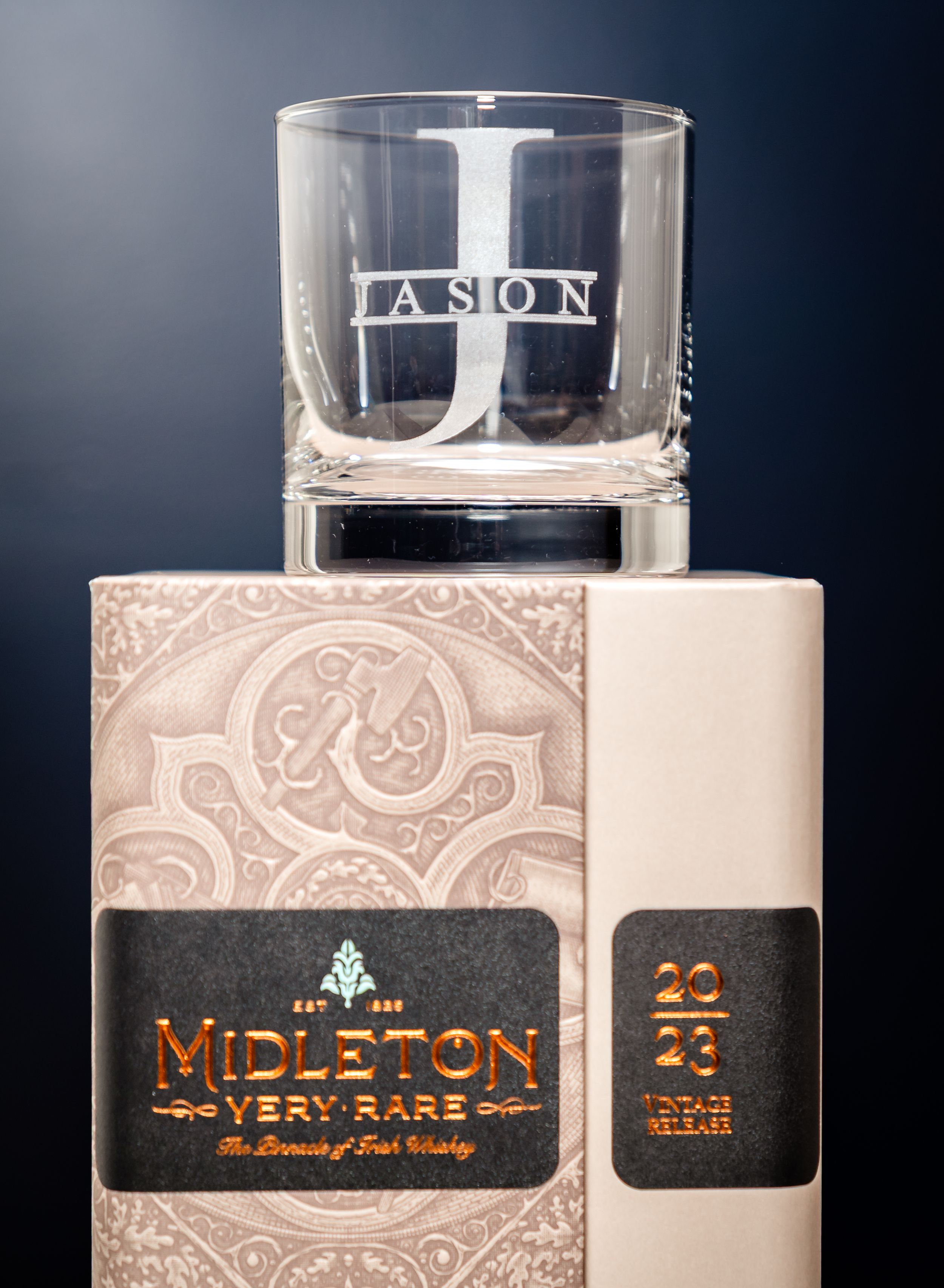 Elegant glass bottle with decorative paisley pattern and custom label.