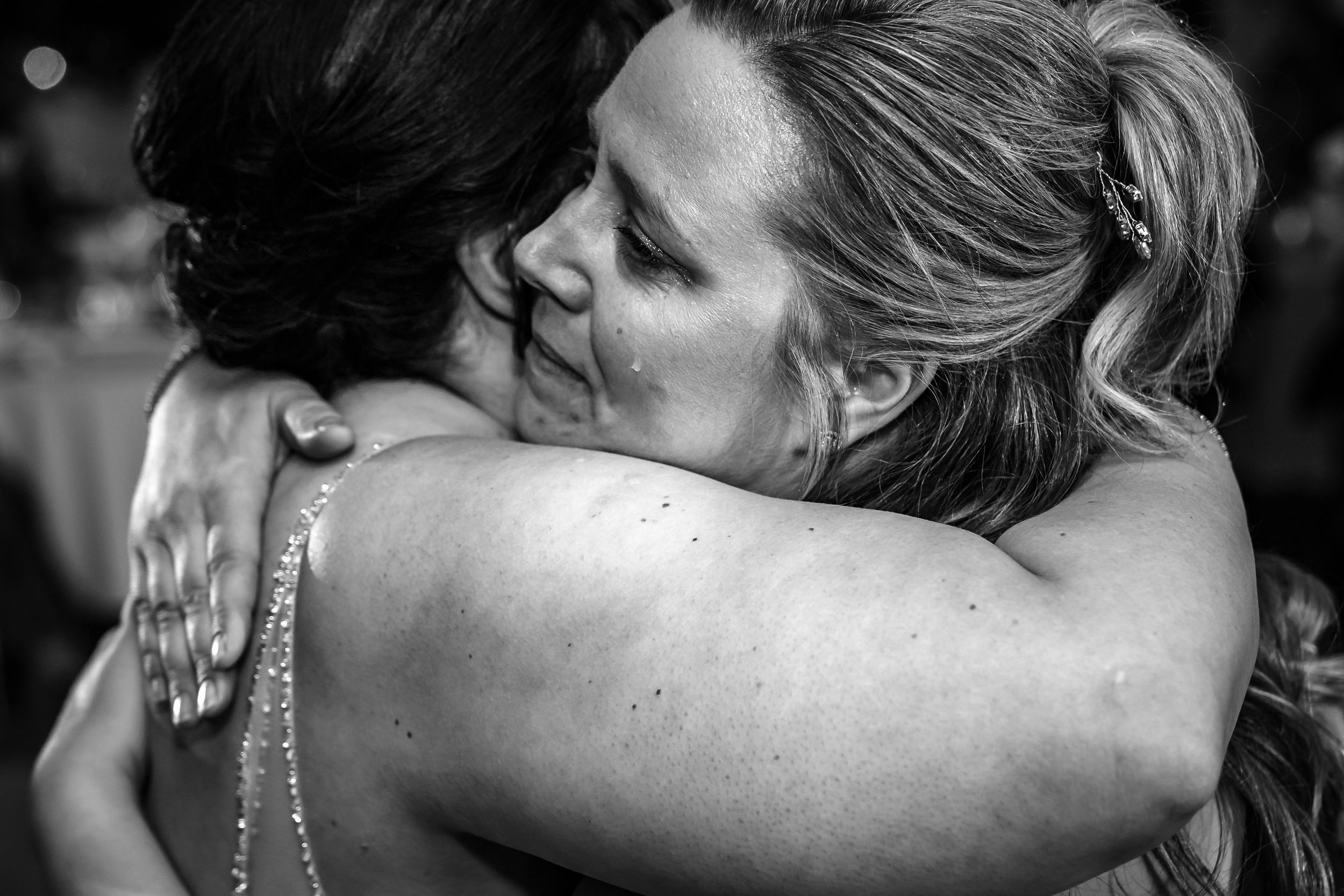 Black and white close-up shots of emotional wedding moments and embraces.