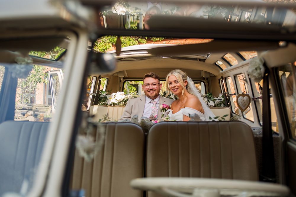 Interior view of a classic VW campervan with cream colored upholstery.