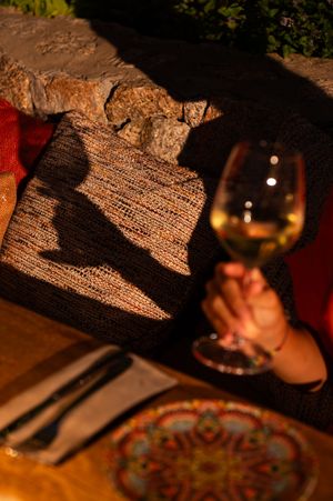 Close-up of menu and drinks on a rustic wooden table in warm lighting.