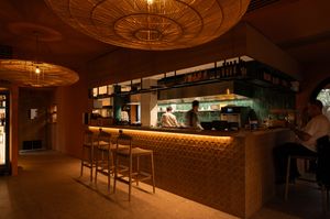Elegant restaurant interior with decorative ceiling lights and bar area.