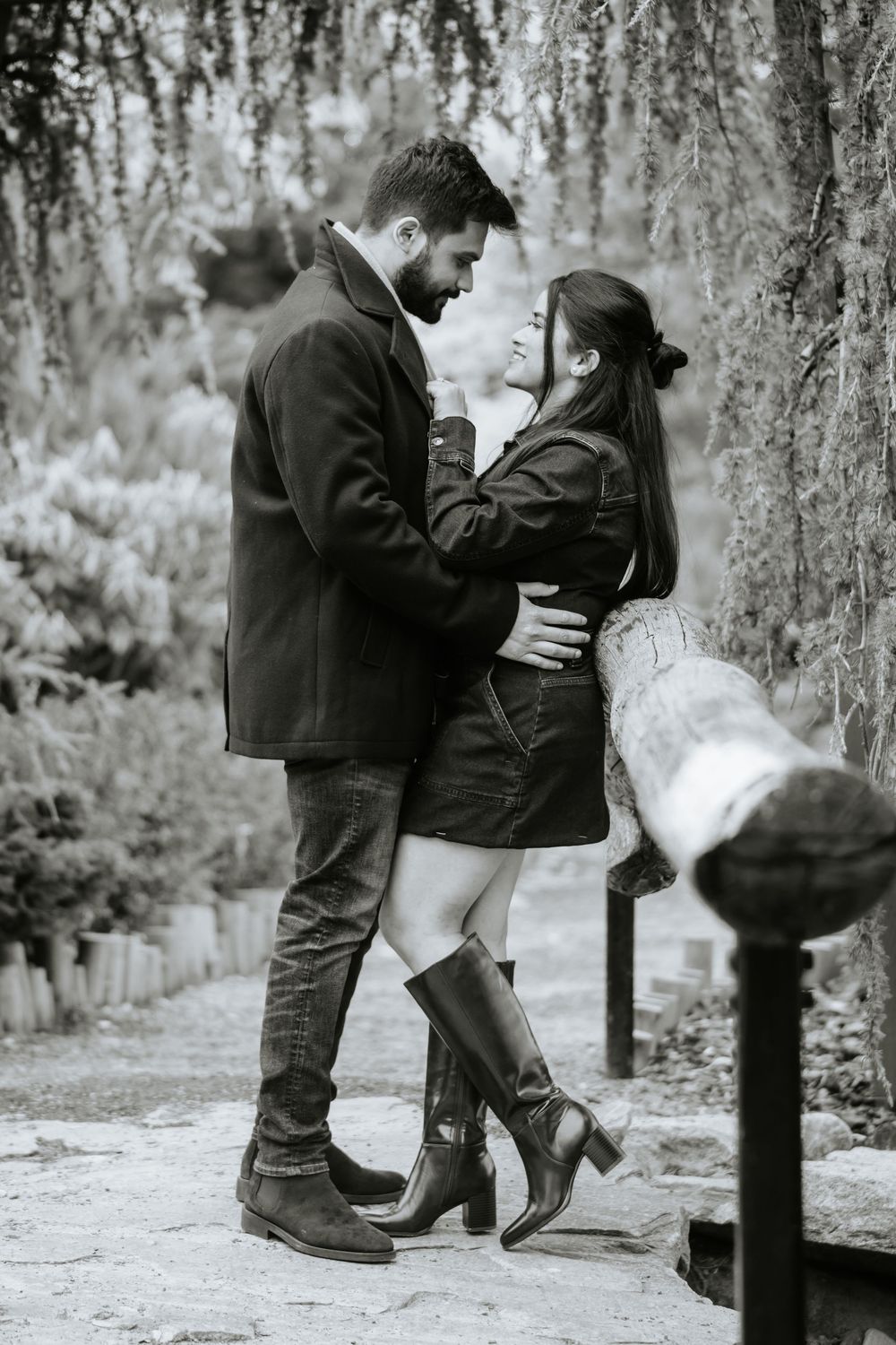 A romantic black and white photo sequence showing a couple dancing and embracing under trees in a park setting.