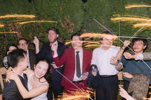 Dallas Wedding guests celebrate with sparklers at a lively outdoor reception exit.