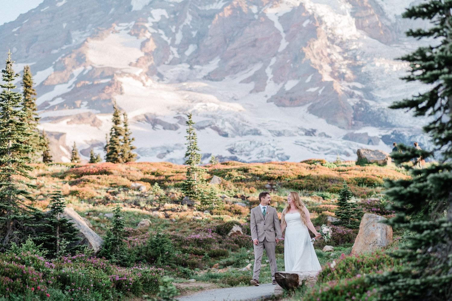 bride and groom walking along Skyline Trail in Mt. Rainier for their elopement day