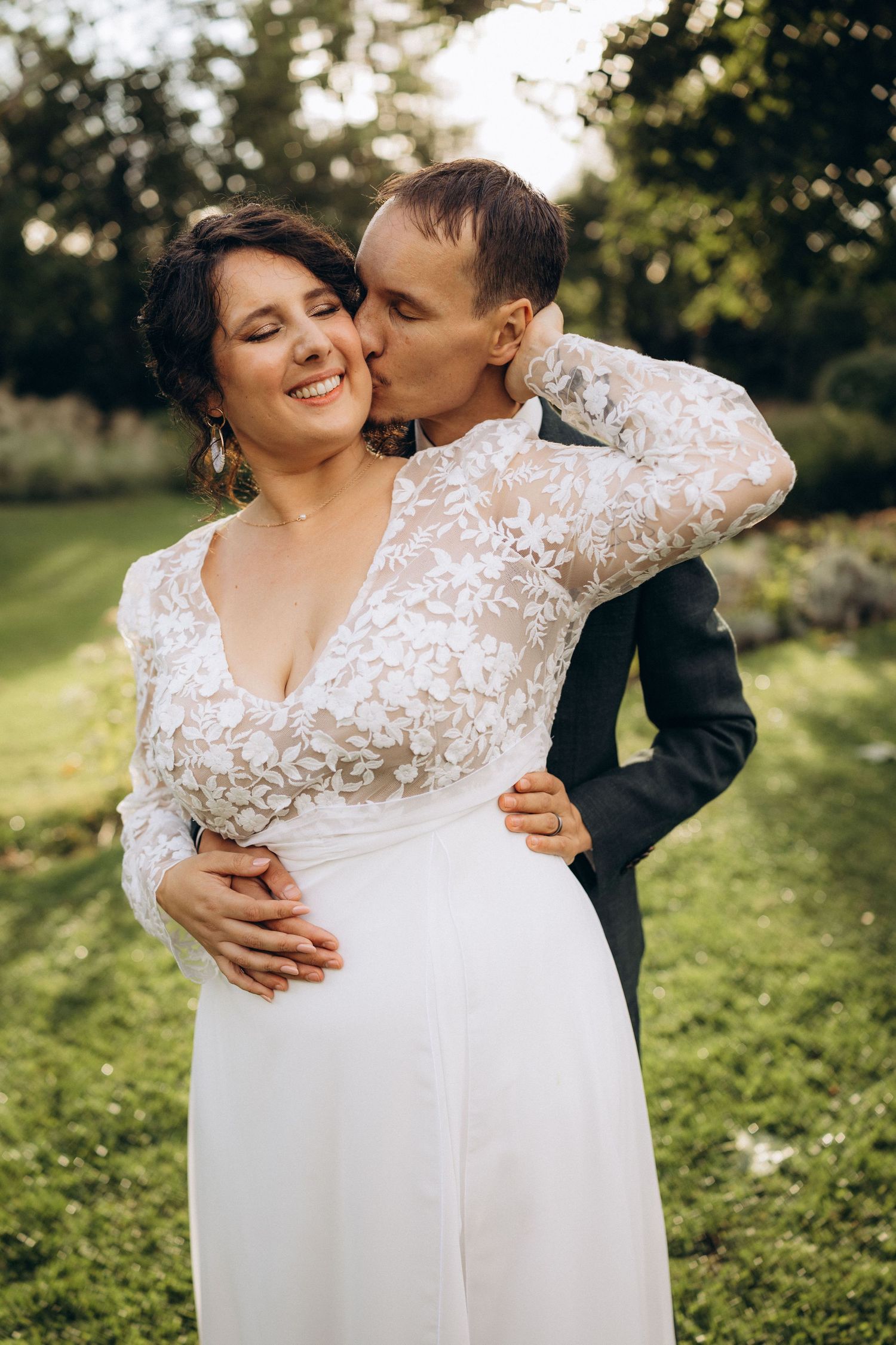 A tender autumn embrace captured during a wedding photoshoot with fall foliage.