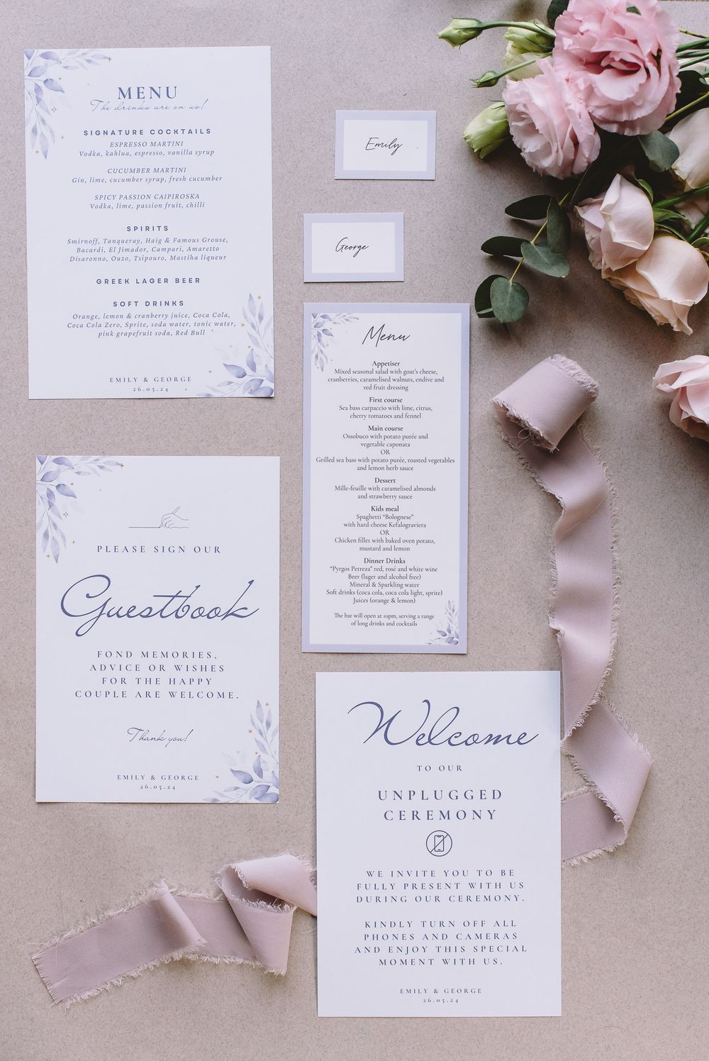 Detailed view of wedding stationery including menu cards and welcome notes with floral design elements.