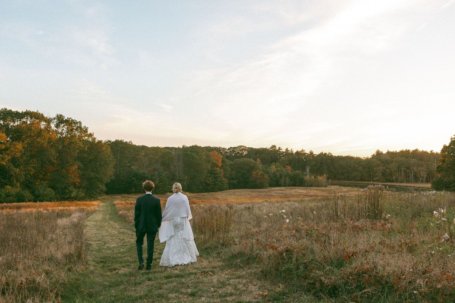 Panoramic view of a wedding venue set against rolling hills and autumn landscape.