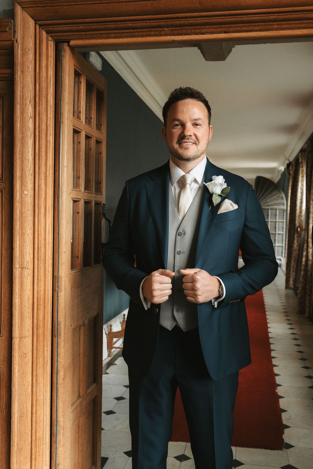 Wedding preparation scene with formal attire in wooden-framed mirrors.