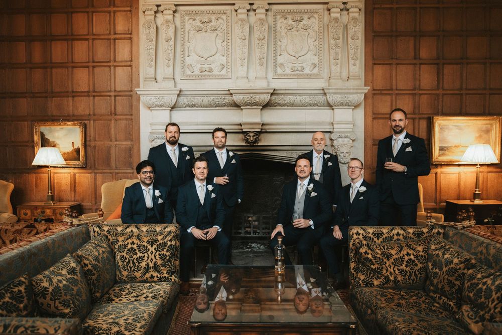 Elegant wood-paneled room with formal gathering and ornate fireplace.
