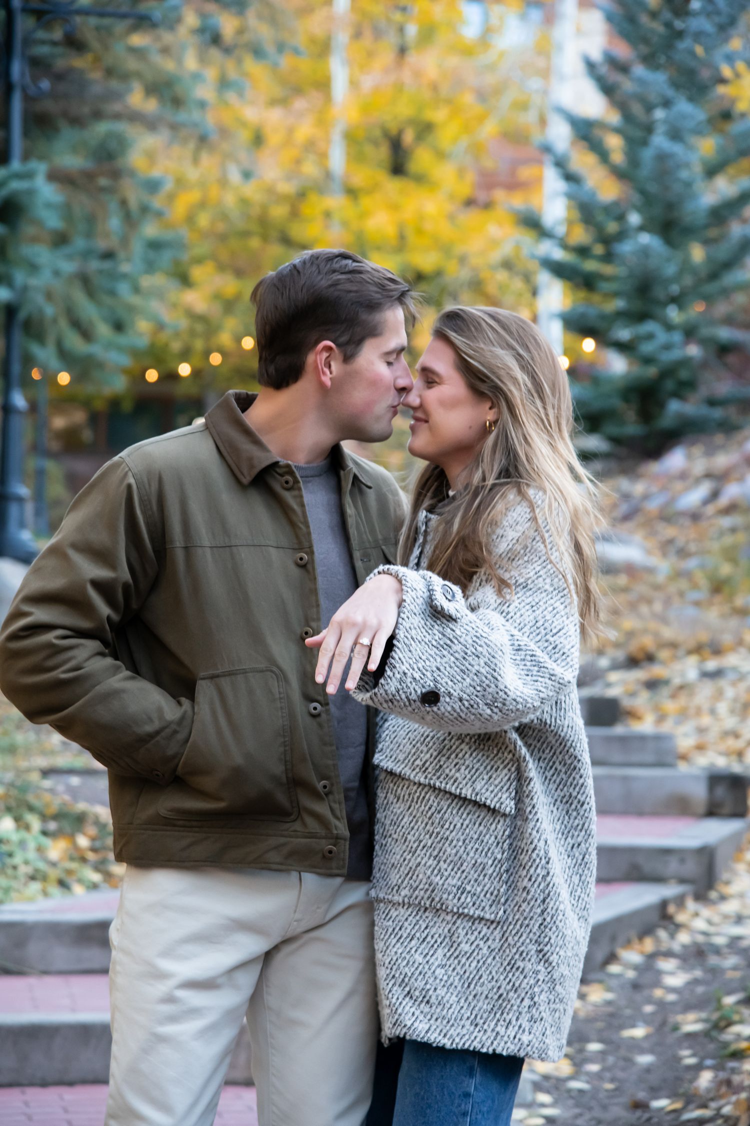 An intimate moment with a cute couple while she shows off her new engagement ring after a surprise proposal in Vail Village in the fall