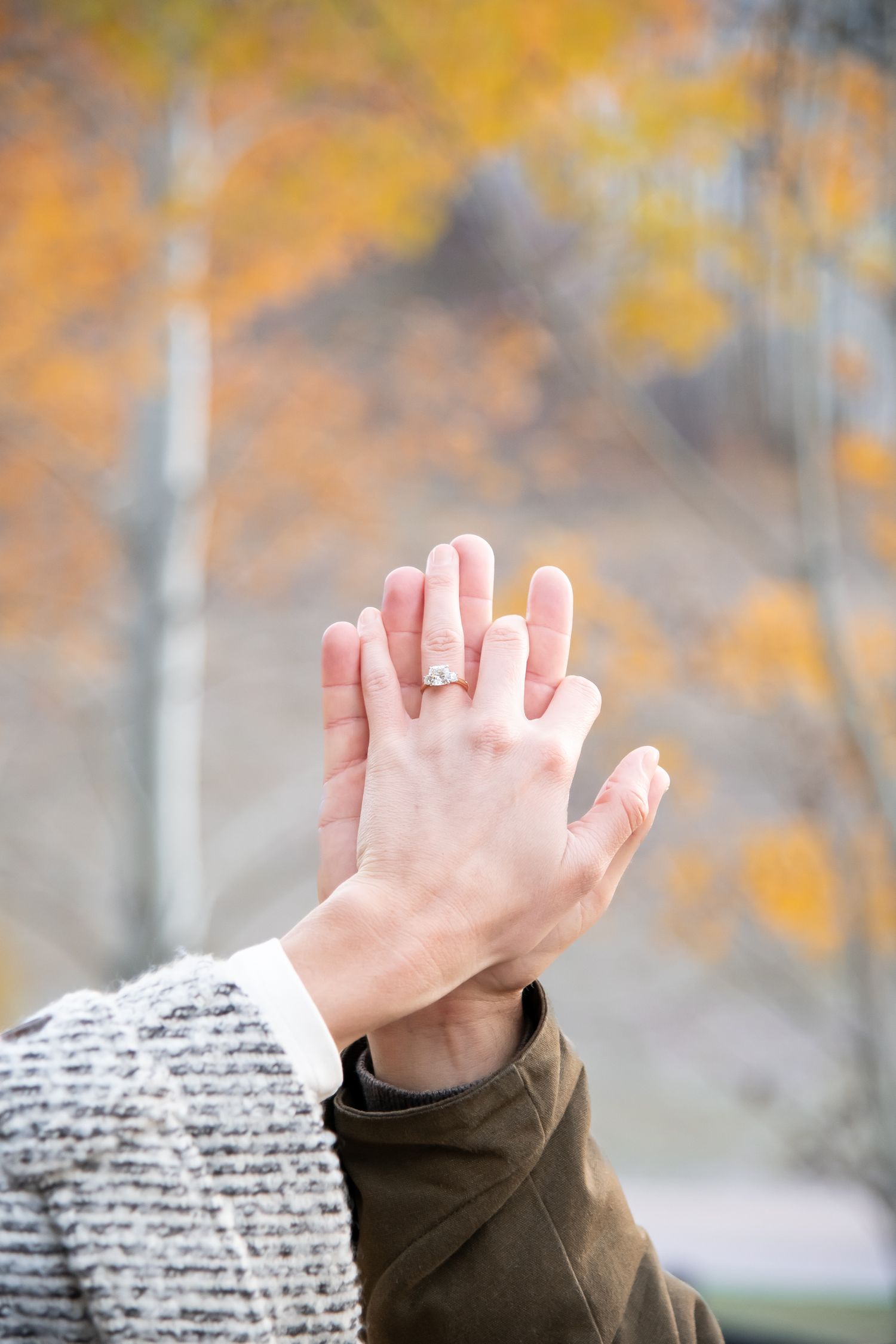 Engagement ring detail photo with evening lighting and soft yellow aspen leaves in the background, taken in Vail Village Colorado