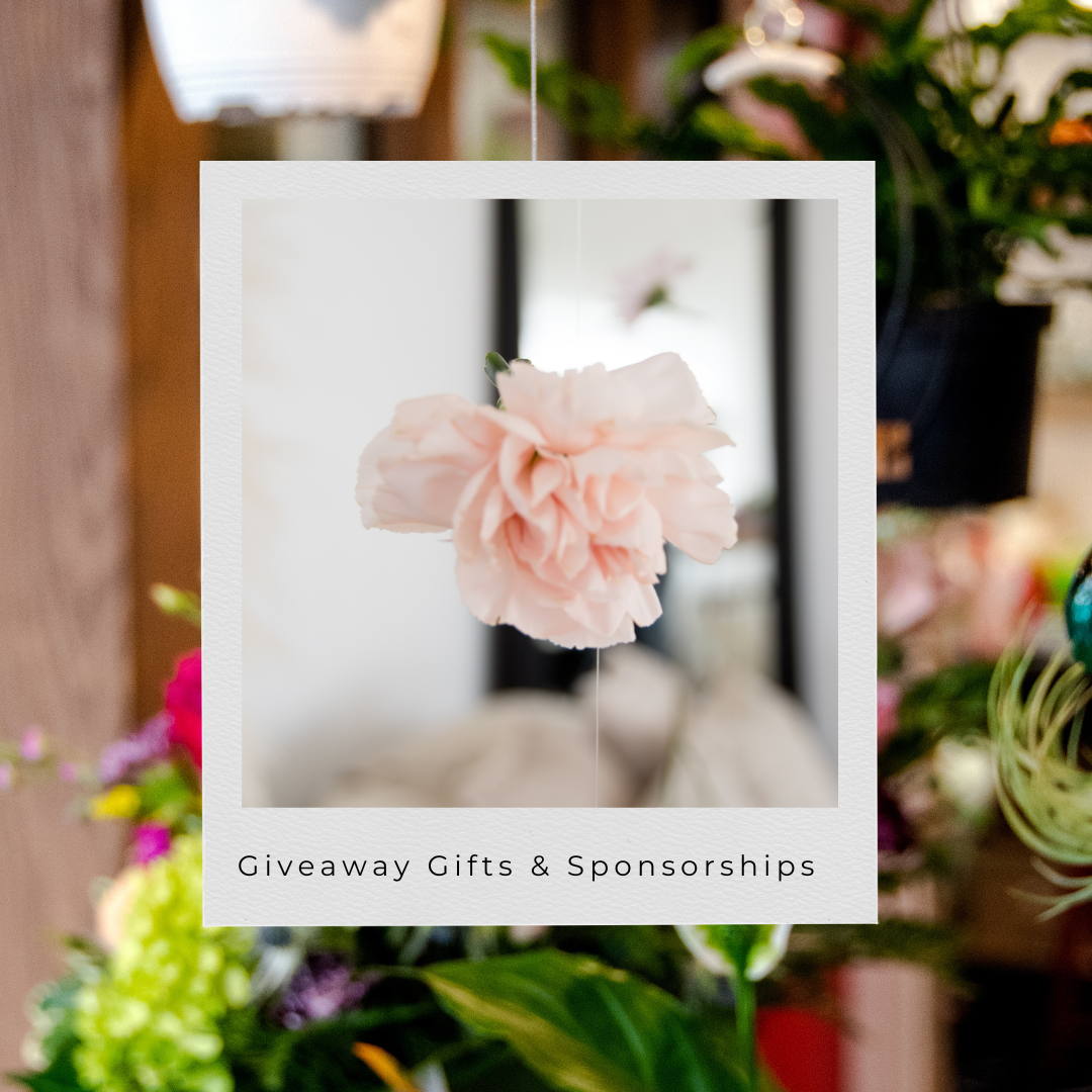 A delicate pink carnation flower in a polaroid-style frame with text reading 'Giveaway Gifts & Sponsorships'.