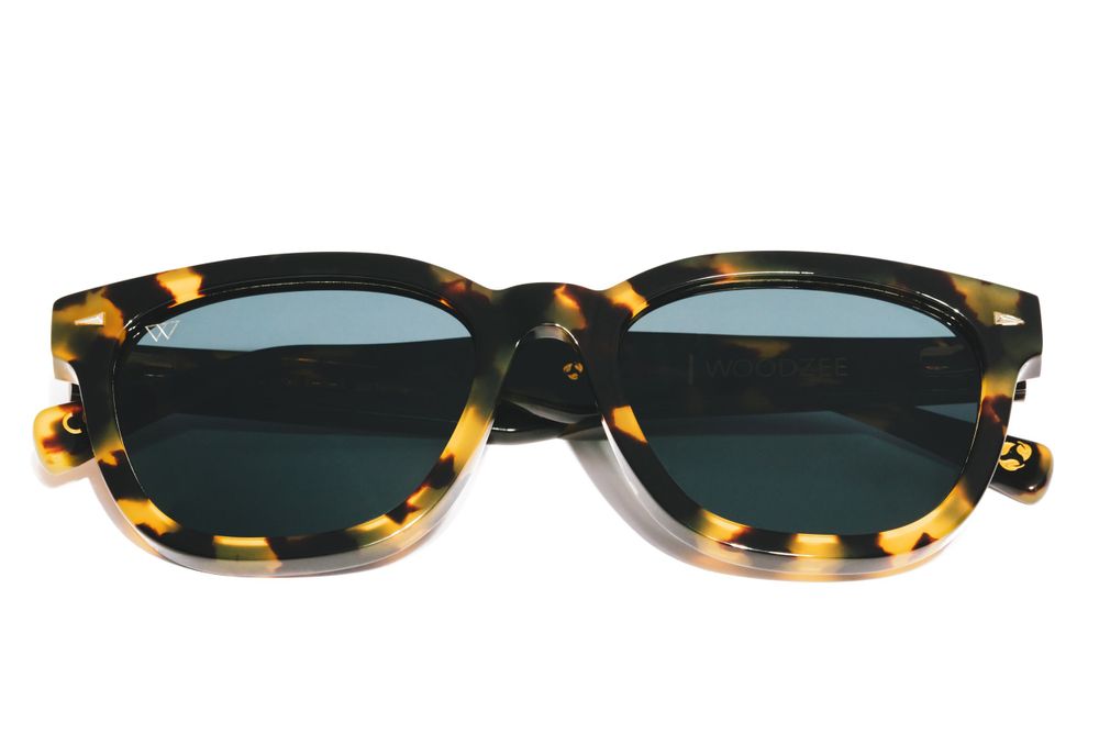 Tortoiseshell pattern wayfarer sunglasses with dark green lenses on white background.