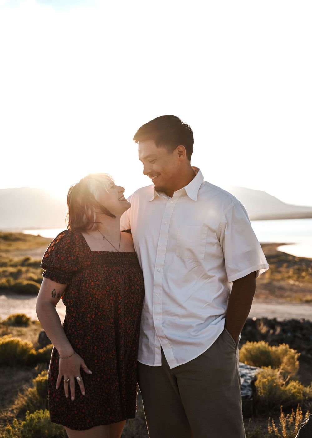 Sunset beach engagement session with golden light and coastal views.