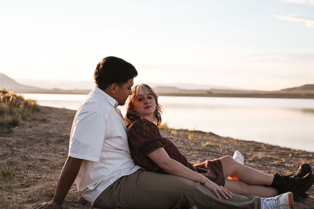Casual beach photoshoot with warm sunset lighting and natural coastal backdrop.