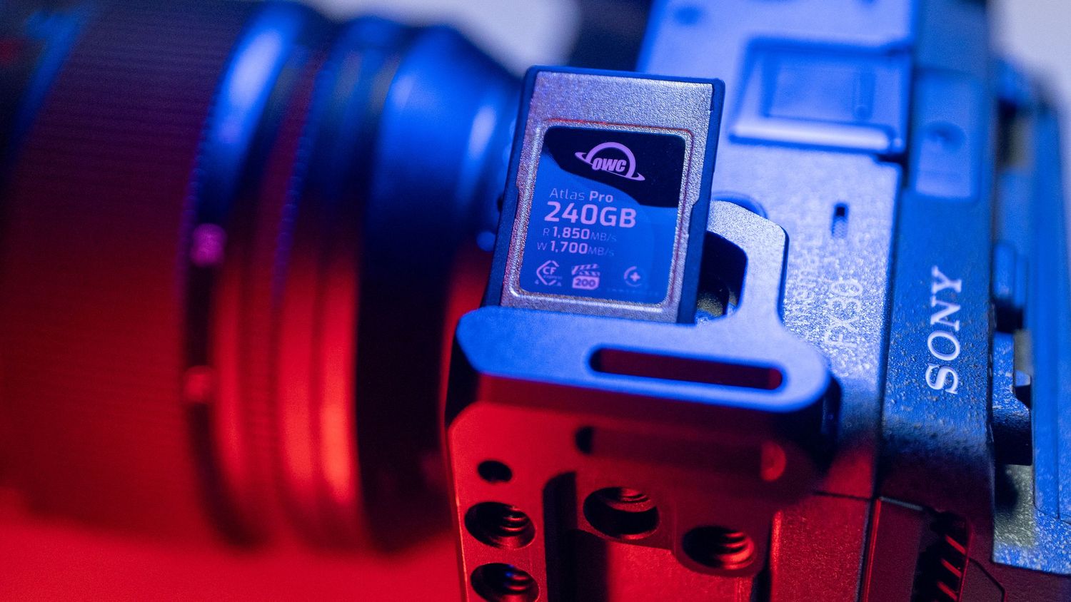 Close-up of a Sony camera memory card slot with blue lighting effects.