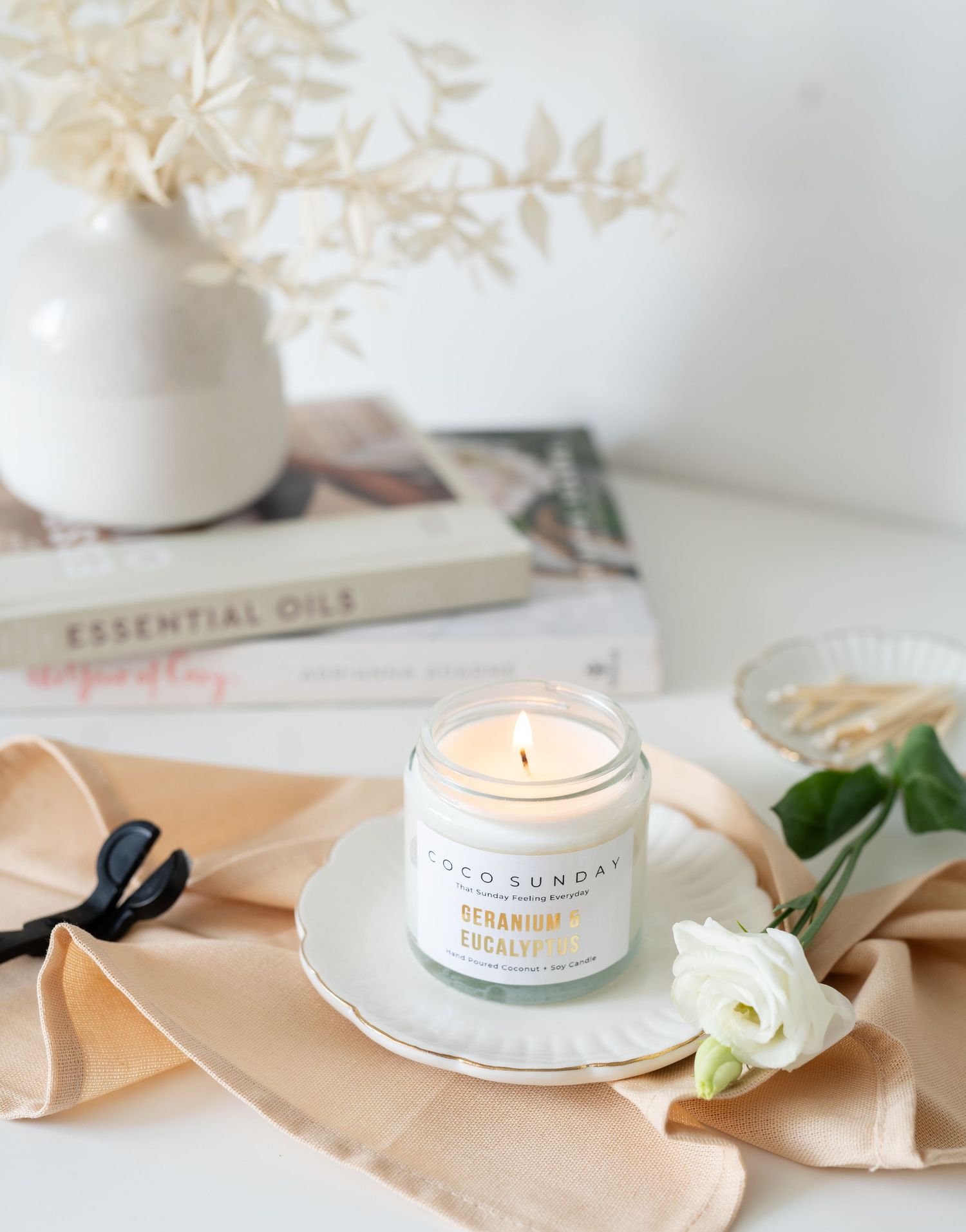 candle styled on desk with wick trimmer and neutral props for lifestyle website photography
