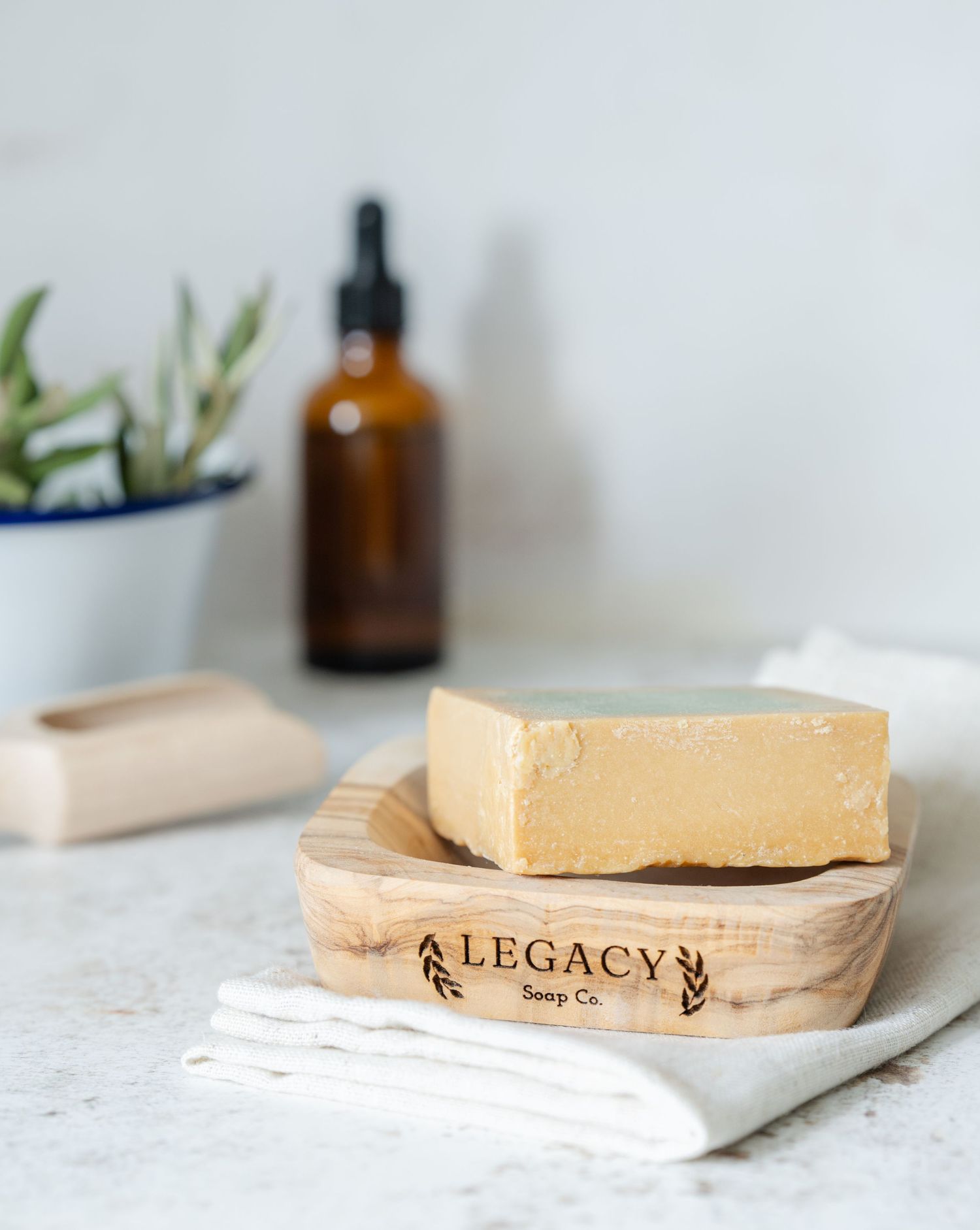 lifestyle product image in studio in Kent of olive oil artisan hand made soap on neutral background with props