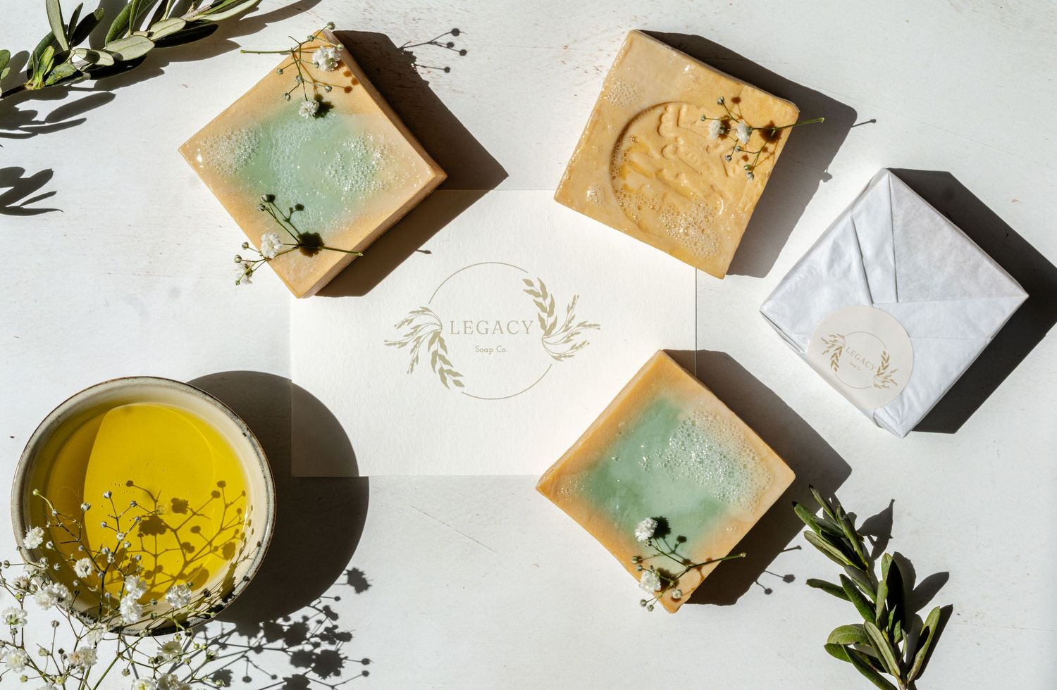 creative product photography for website and social media content of olive oil soaps' in natural light