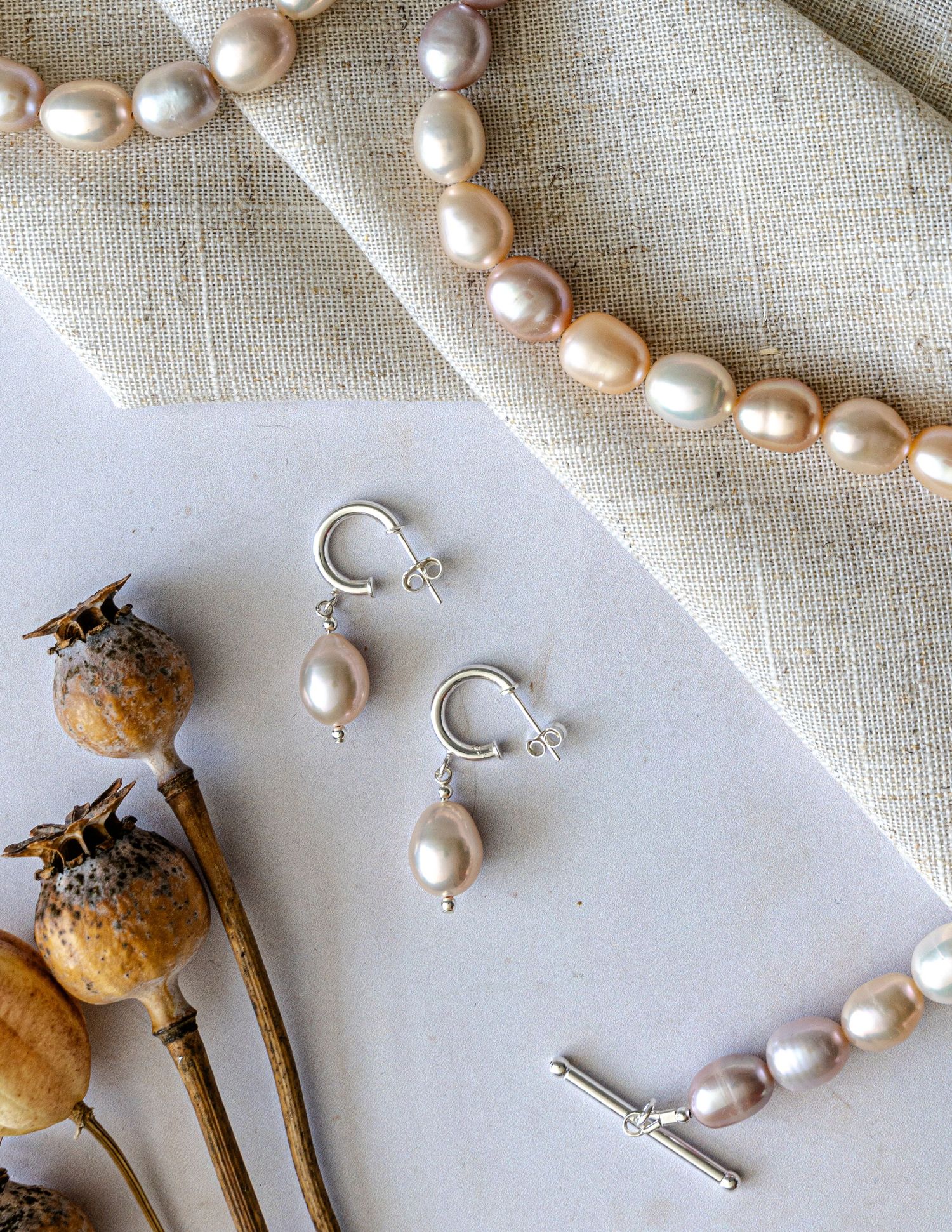 flatlay jewellery product photography of pearls with natural elements