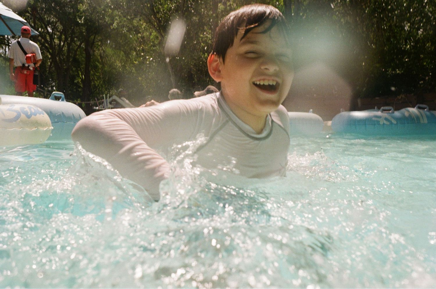 A sequence of close-up splashing photos capturing movement and water droplets in a sunlit pool.