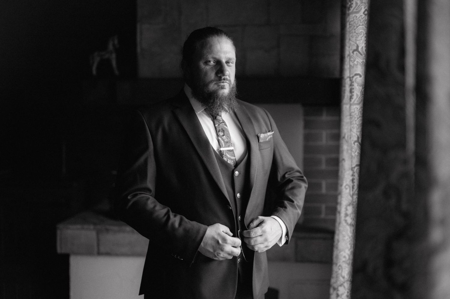 Professional black and white portrait series showing various expressions and poses in dramatic lighting.