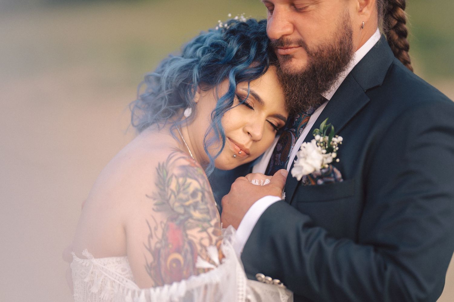 A tender intimate wedding moment captured with soft lighting and delicate floral details.