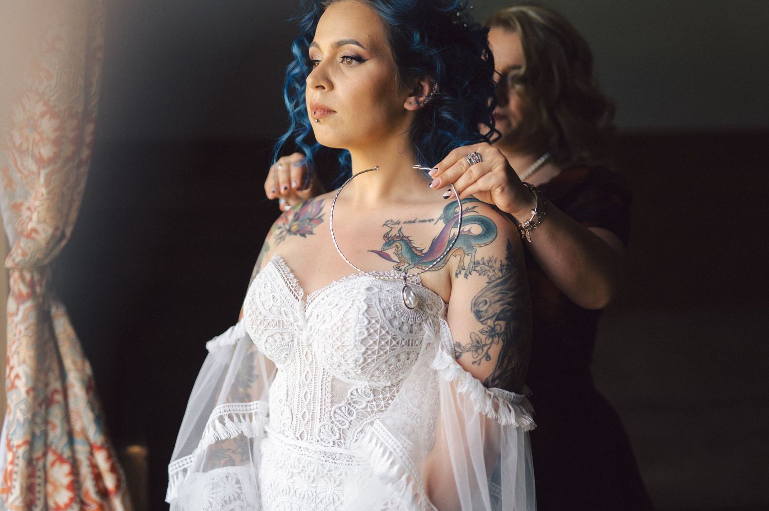 Elegant bridal wedding photographs showing white lace dress details, floral sleeves, and tattoo designs in artistic lighting.