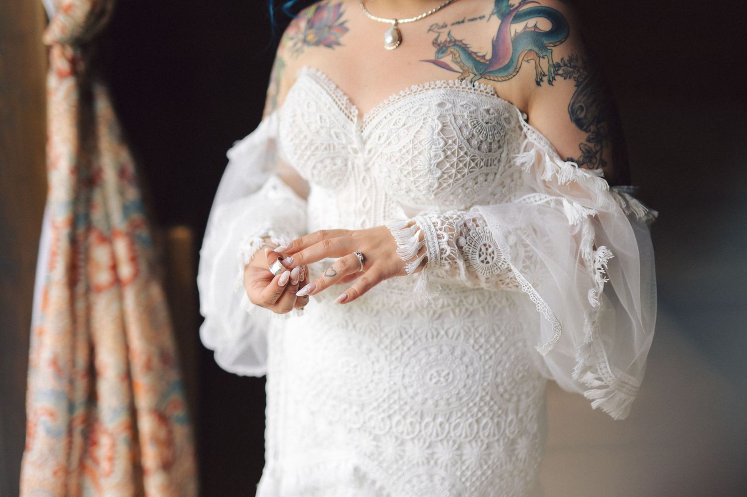 Close-up shots showing delicate details of a white lace wedding dress with a romantic strapless neckline and intricate embellishments.