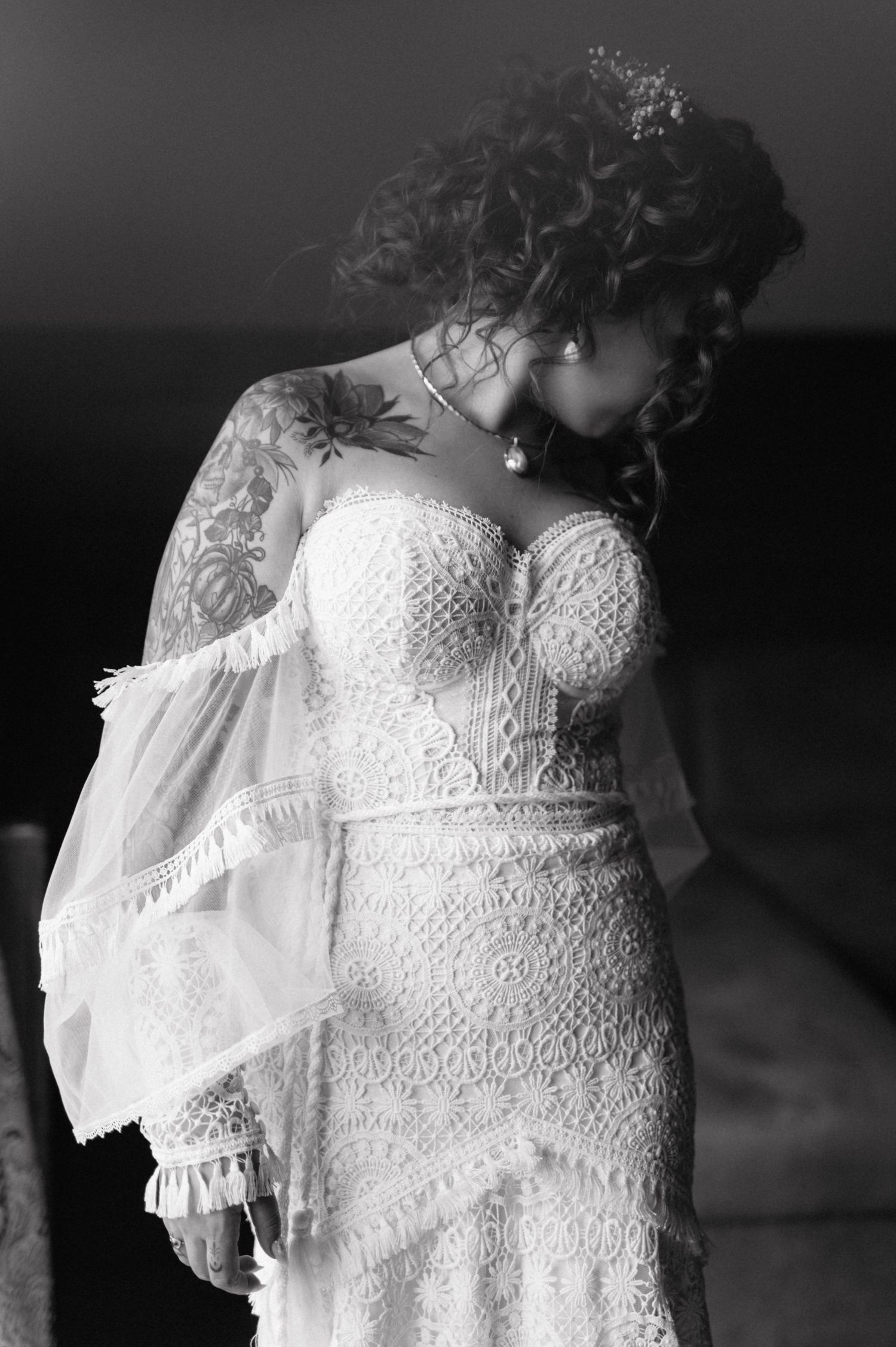 A series of detailed black and white photographs showing wedding dress bodices with delicate lace and beading patterns.