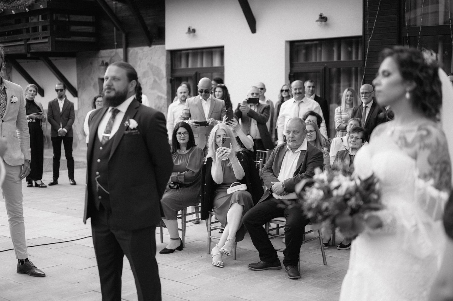 Wedding guests dance and celebrate during an outdoor reception celebration.