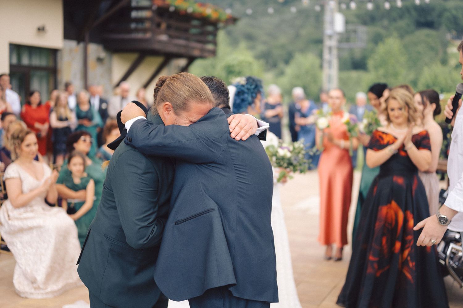 Couples dancing together at an outdoor wedding reception celebration on a sunny day.