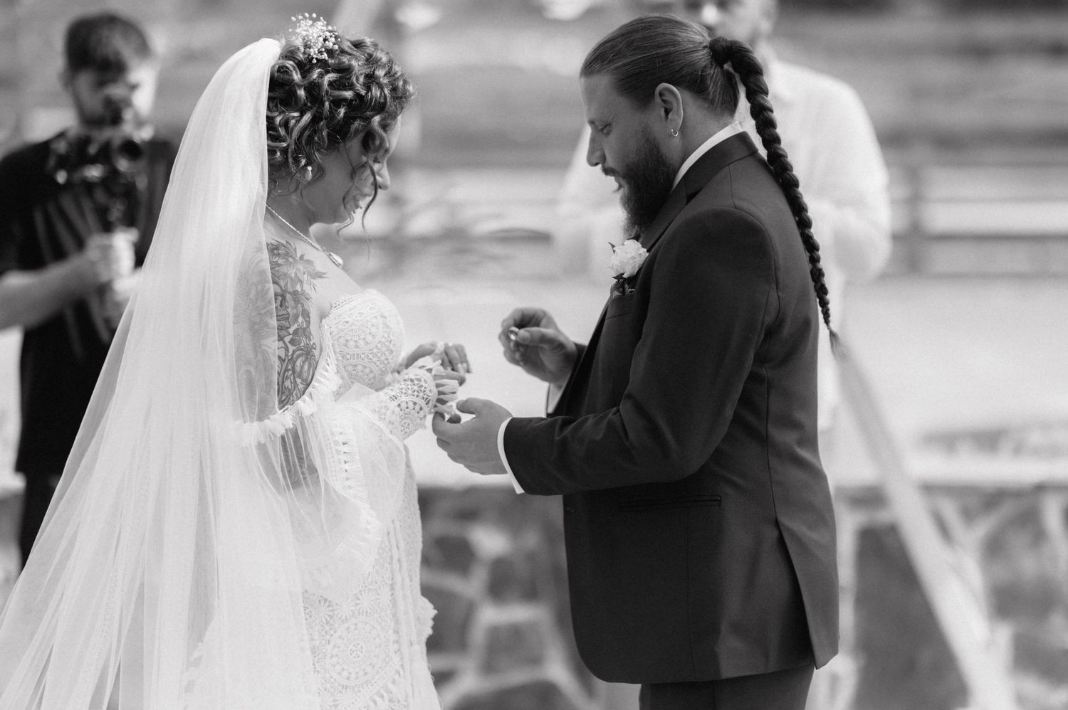 A black and white wedding photo montage showing four intimate moments during a traditional wedding ceremony.