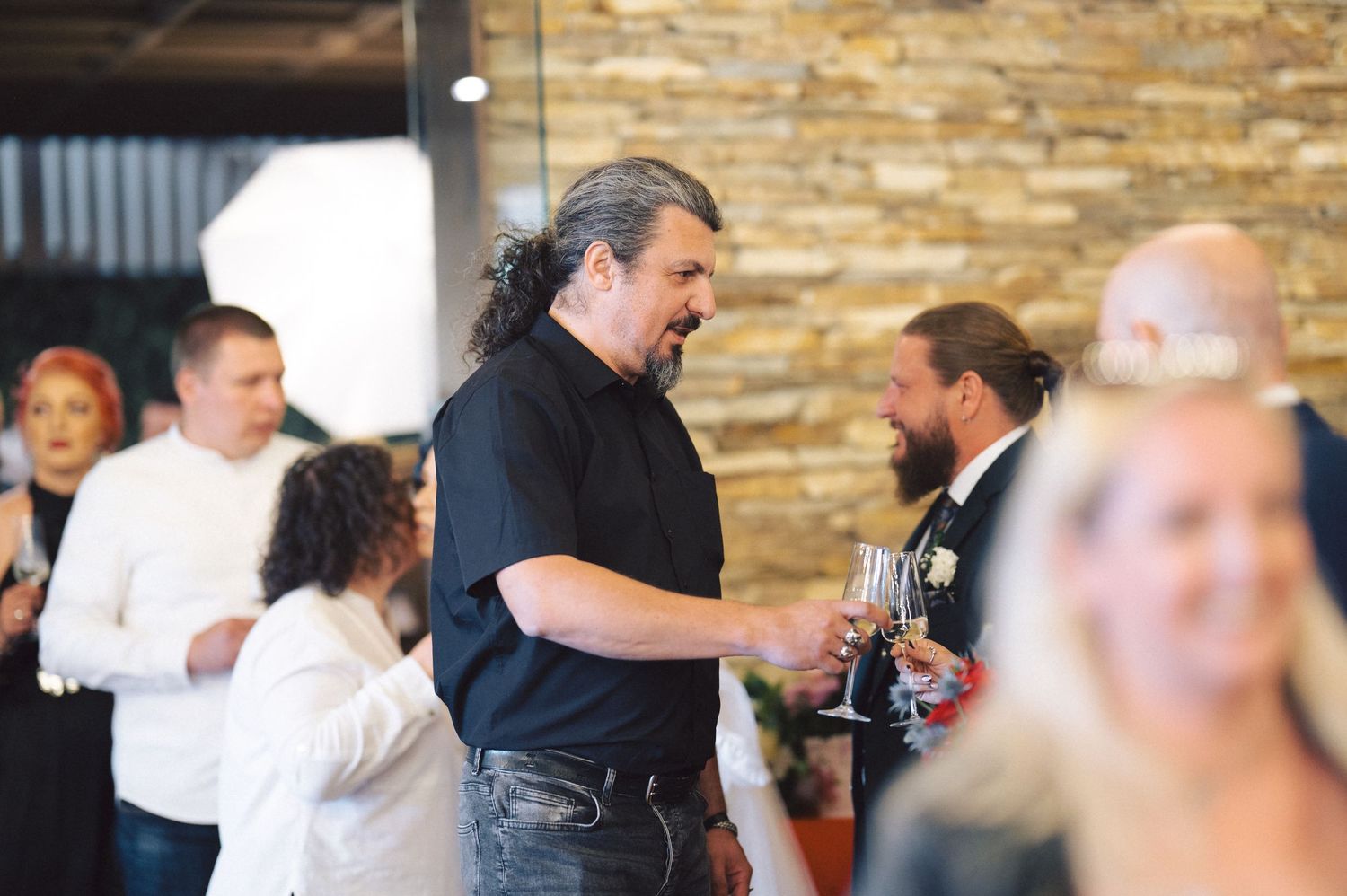 People are seen mingling and socializing during what appears to be an informal gathering or event.