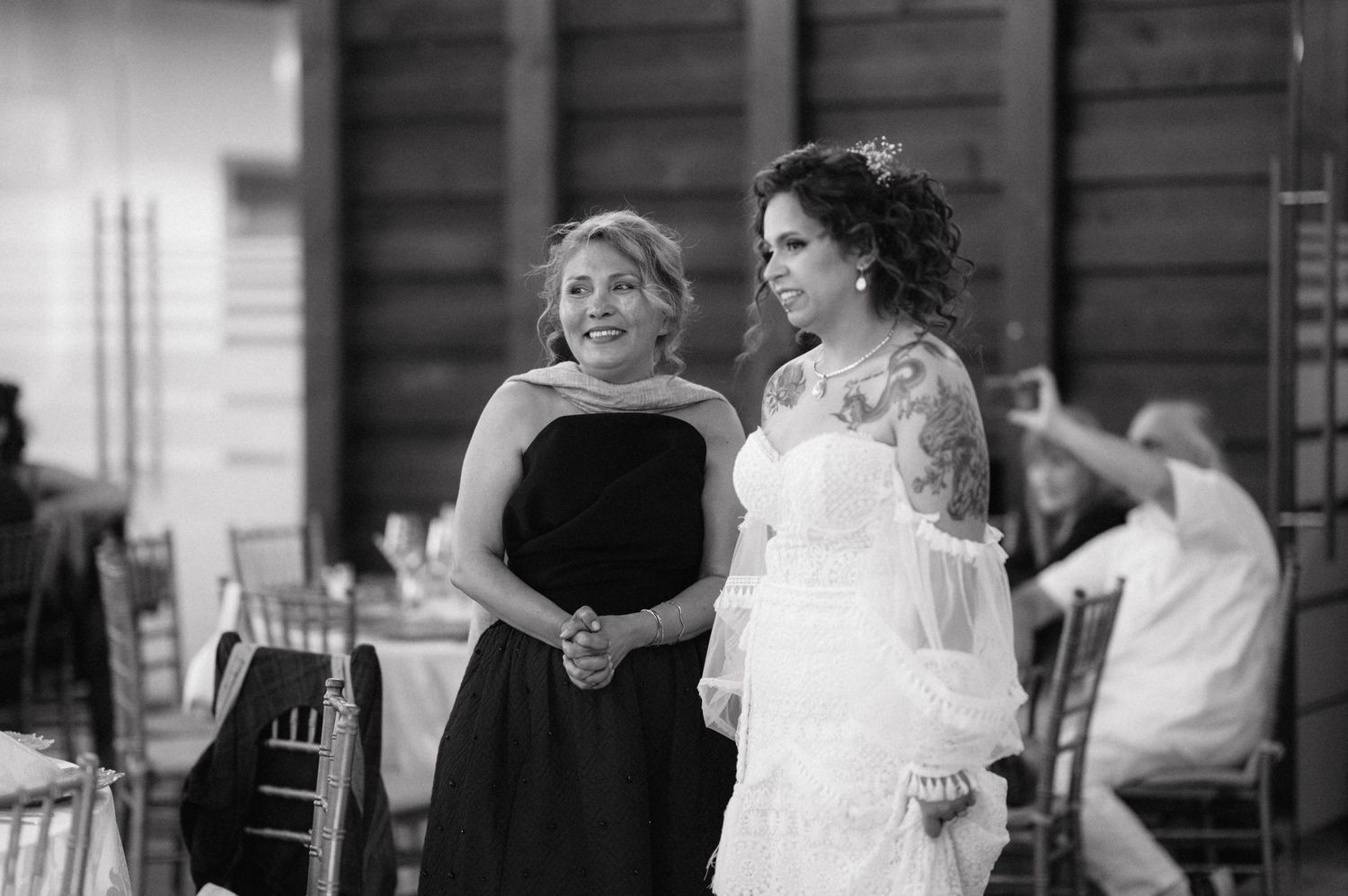 A series of black and white wedding photographs show couples dancing and celebrating together at a reception.