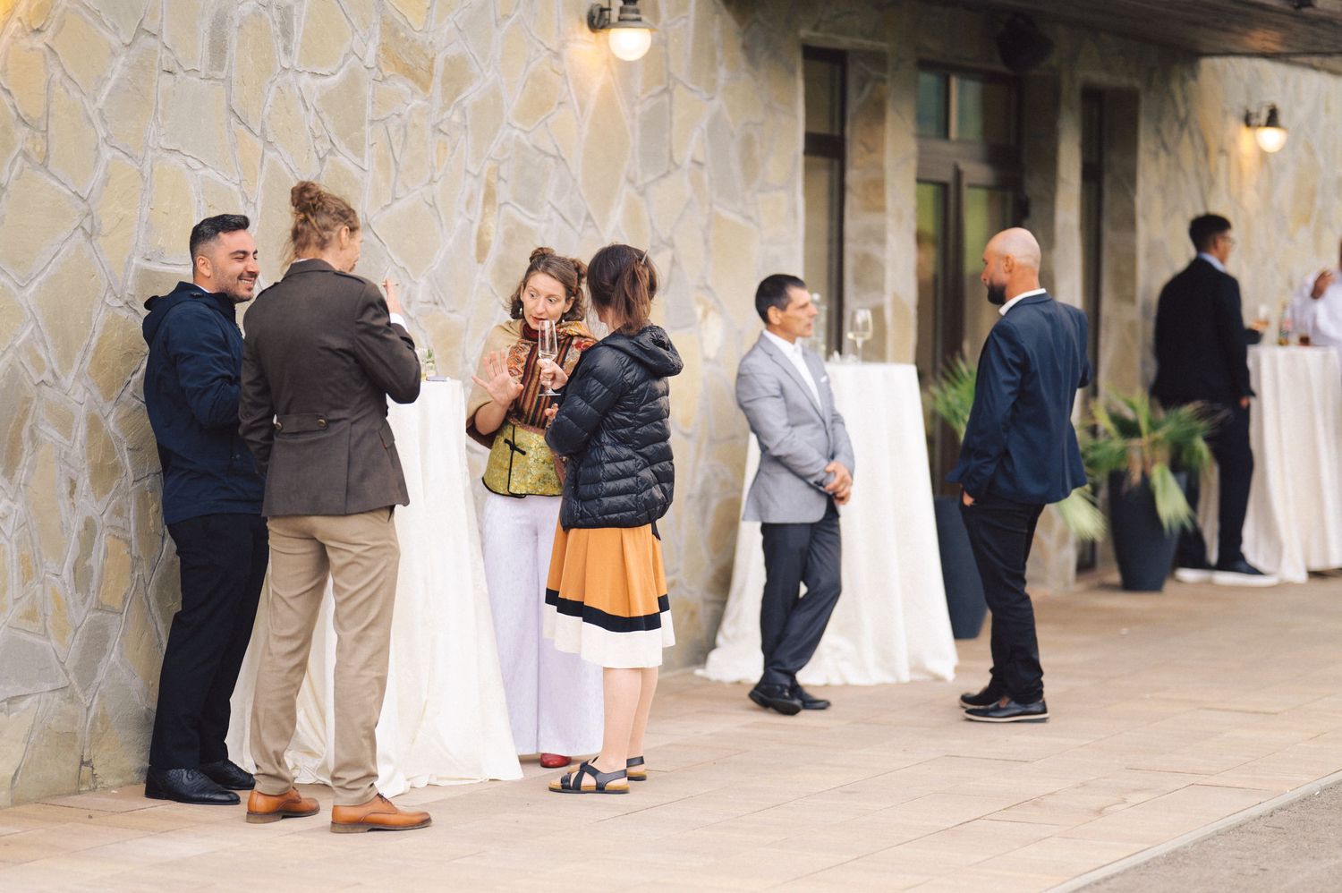 A panorama sequence of wedding guests mingling at a formal reception in an elegant venue hall.