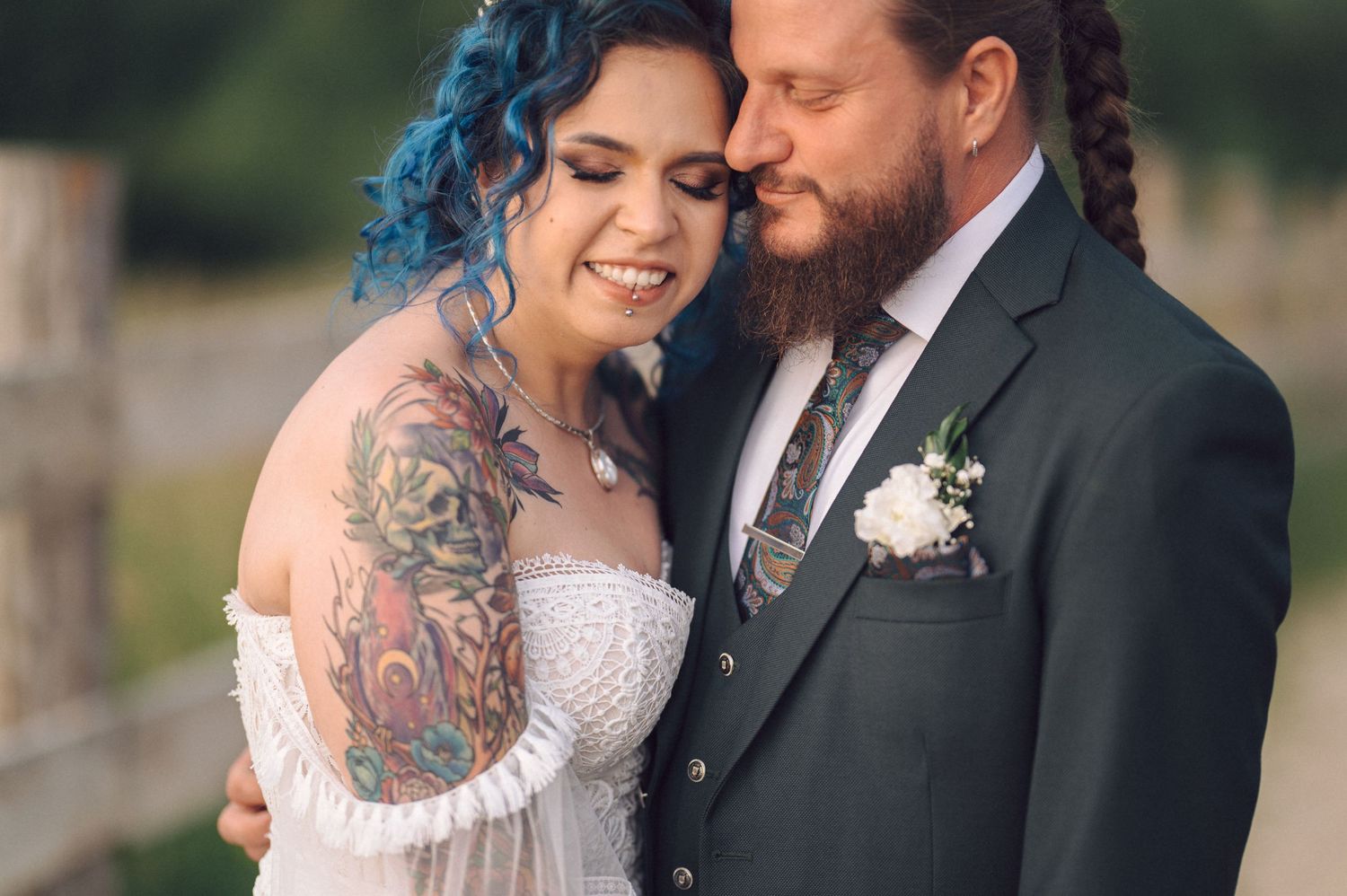 A couple share an intimate moment during their wedding day while dressed in elegant formal attire.
