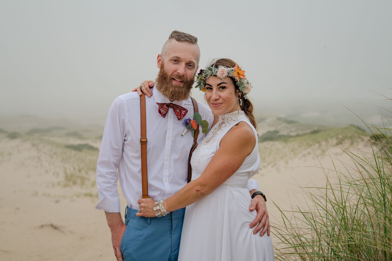 Newlyweds during their wedding day portrait session on a foggy afternoon on the Provincetown dune trail.