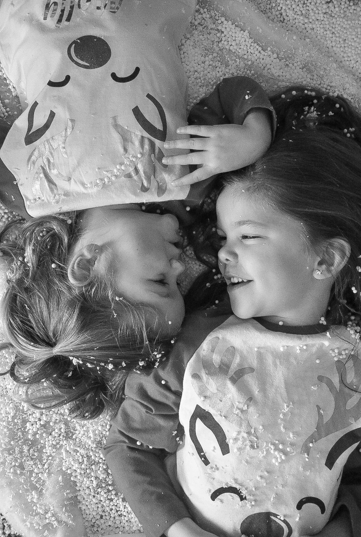 Black and white portrait series with glitter and playful expressions.